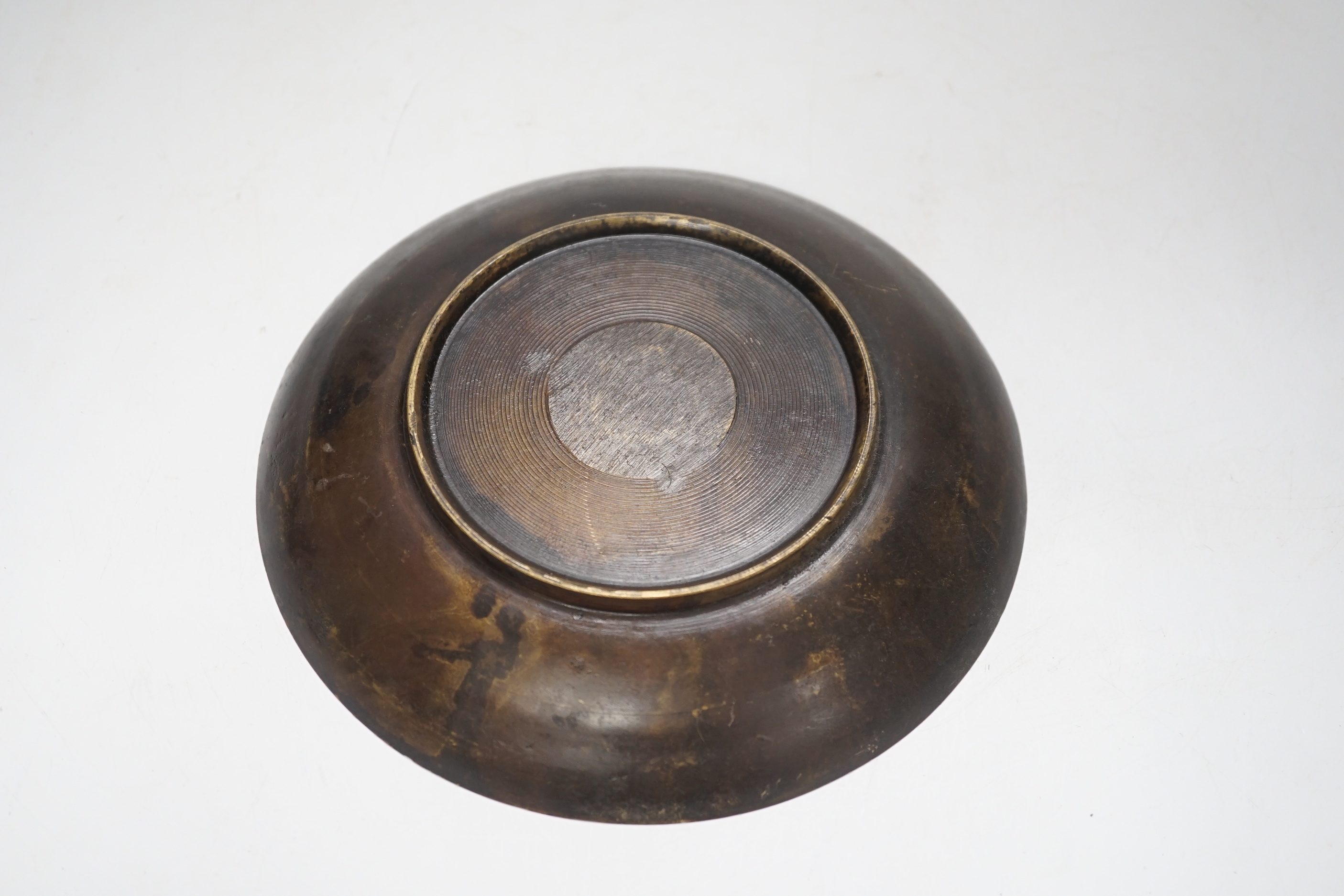 A Chinese bronze dish, 'coin' design to the centre, 18cm diameter